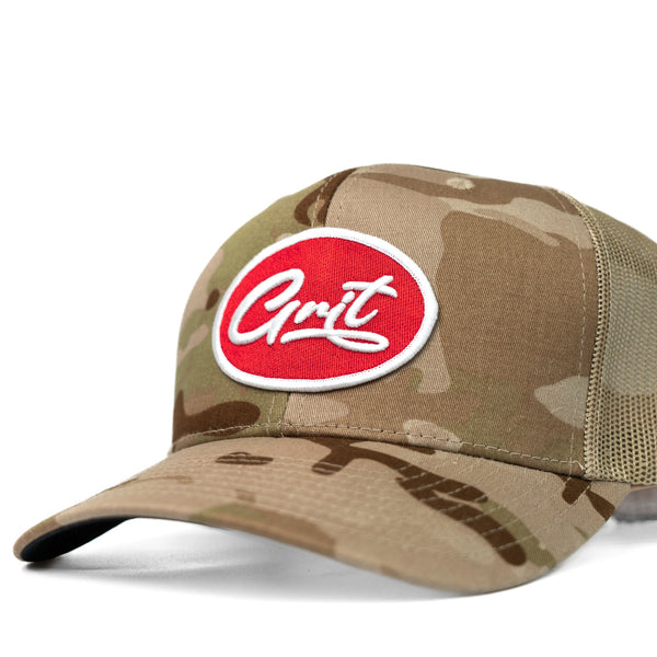 Camouflage baseball cap with a red and white logo on a white background