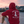 Person wearing a red hoodie with 'West Island Yacht Club' logo on a boat at sunset.